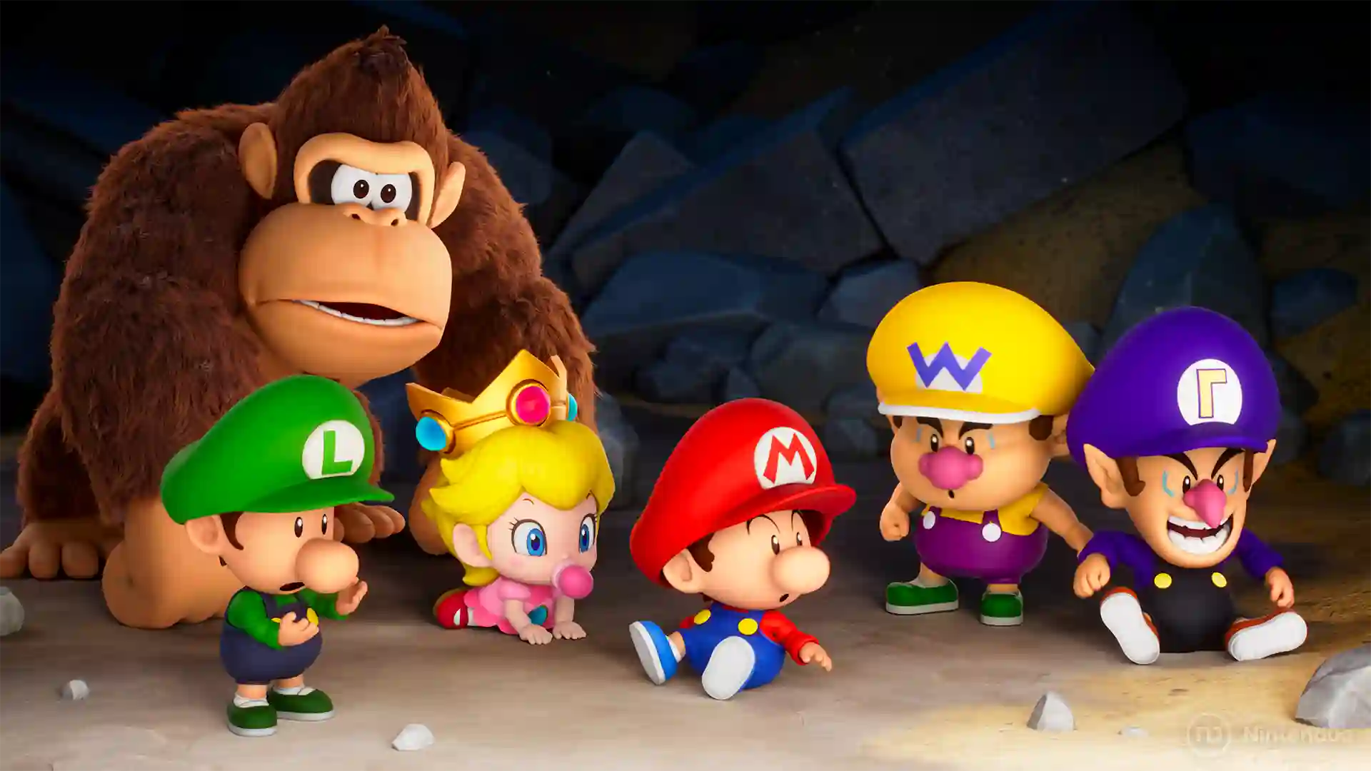 Mario Tennis Fever – Donkey Kong observa desde atrás a un grupo de versiones bébé de los personajes: Baby Luigi, Baby Peach, Baby Mario, Baby Wario y Baby Waluigi sentados o de pie en el suelo con expresiones sorprendidas.