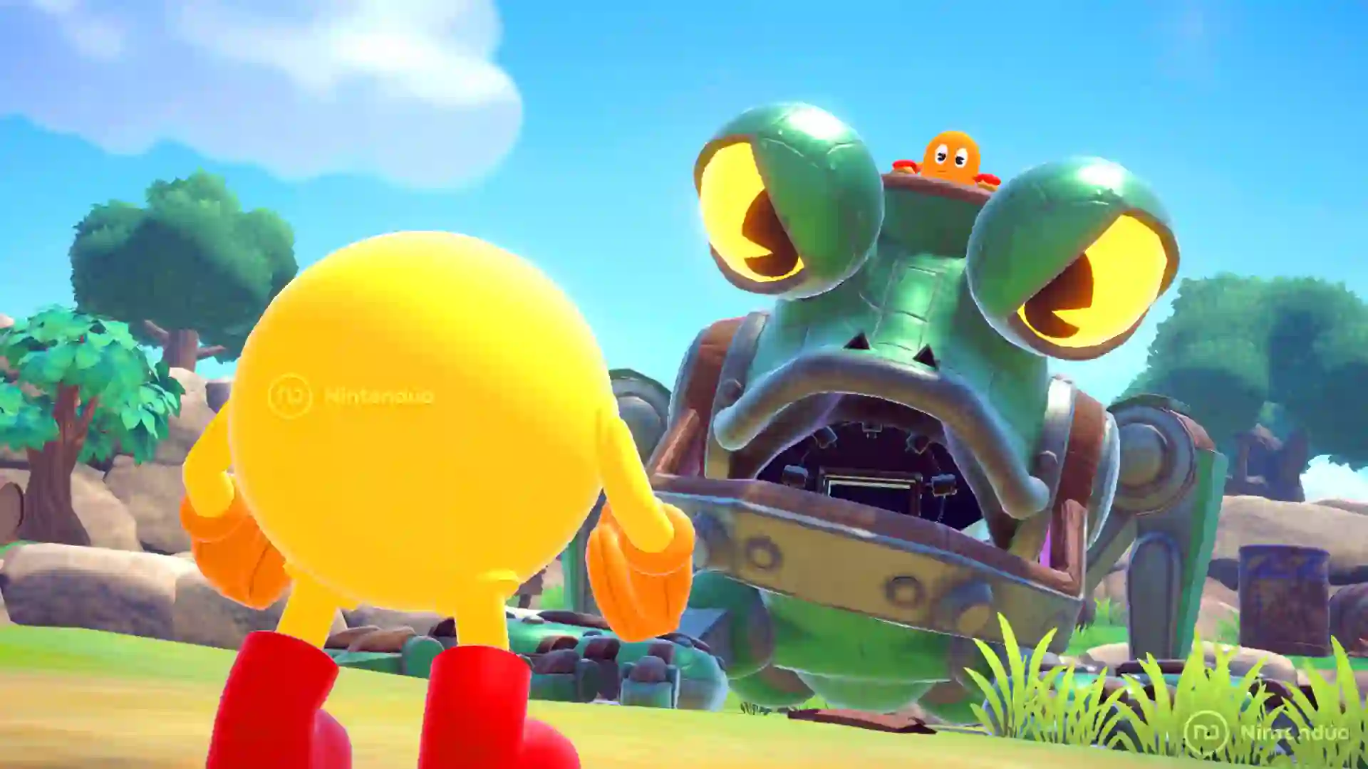 Pac‑Man se enfrenta a una enorme rana mecánica con ojos verdes en Pac‑Man World 2 Re‑Pac durante un nivel al aire libre.