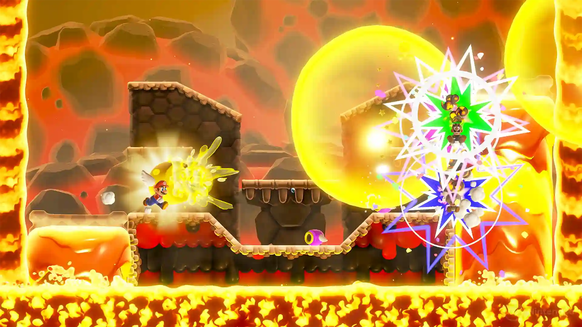 Super Mario Bros. Wonder – Nintendo Switch 2 Edition: Mario corre por un nivel volcánico rodeado de lava mientras activa una superestrella dorada que genera destellos de colores.