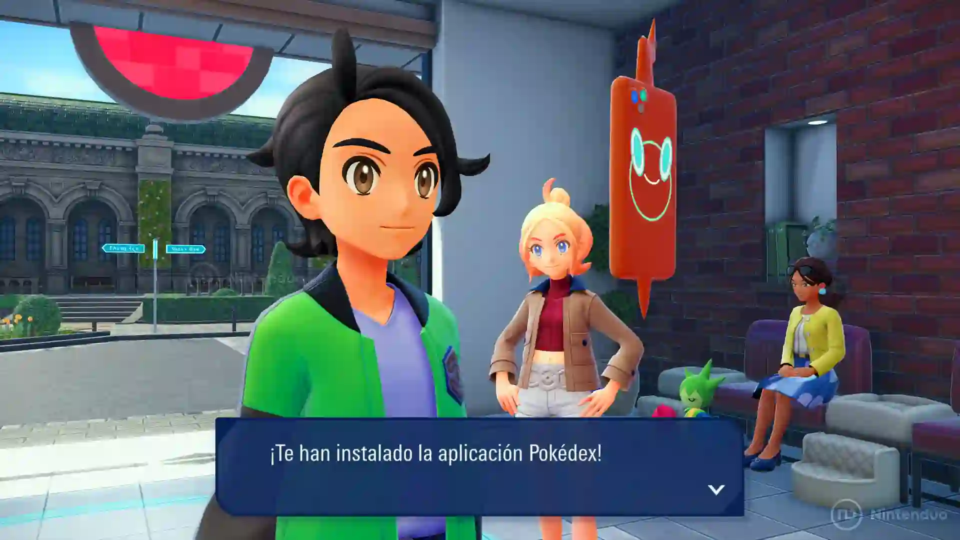 Escena de Leyendas Pokémon Z-A para Nintendo Switch 2 en la que el protagonista recibe la notificación de que le han instalado la aplicación Pokédex, con el icono de Rotom en la pared y dos entrenadoras a su lado.