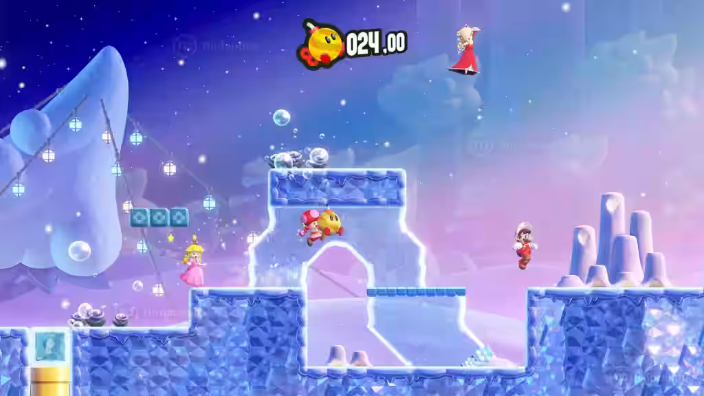 Peach y otros personajes recorren un nivel helado con plataformas de hielo y burbujas en Super Mario Bros. Wonder.